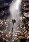 NYC Image  Reuters. In the aftermath of the September 11, 2001 terrorist attacks on the World Trade Center in New York City, firemen and rescue workers search for survivors, and extenguish flames in the massive rubble from the 09-11-2001 attack.